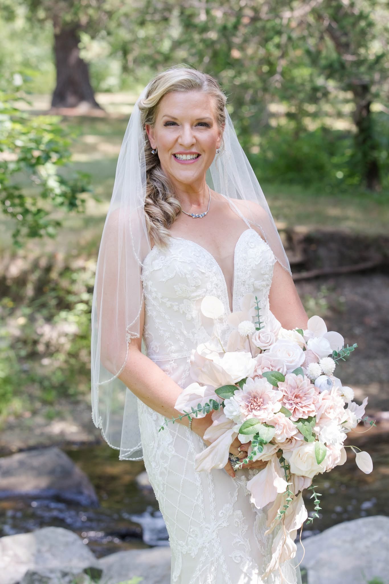 Bride wearing veil, holding bouquet